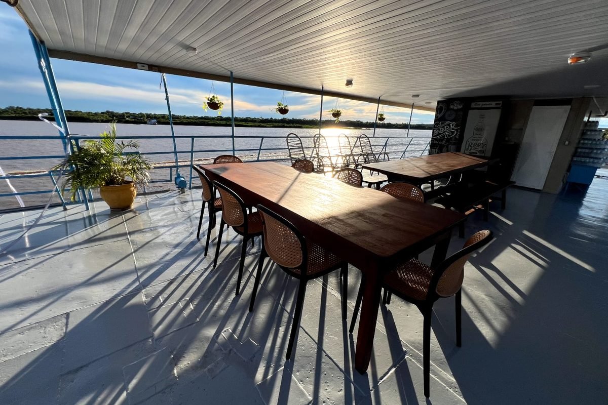 Deck do Barco Hotel Matucho com mesas ao pôr do sol no Araguaia